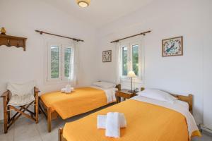 a room with two beds and two windows at Libyan Sea Sunset in Kerames