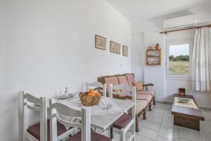 a living room with a table with a bowl of fruit on it at Libyan Sea Sunset in Kerames