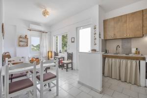a kitchen and dining room with a table and chairs at Libyan Sea Sunset in Kerames +33 photos