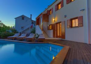 a house with a swimming pool next to a house at Villa San Vista with pool in Sveti Vid-Miholjice
