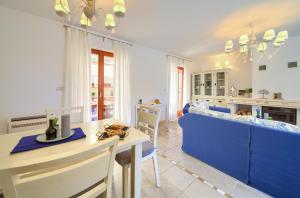 a kitchen and living room with a table and a couch at Villa San Vista with pool in Sveti Vid-Miholjice +35 photos