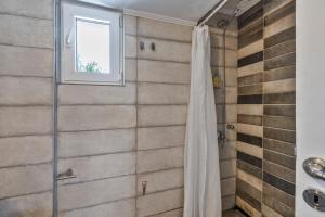 a bathroom with a shower with a shower curtain at Libyan Sea Sunset in Kerames