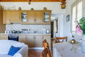 a kitchen with a couch and a table in a room at Kastanies Ananias Skopelos in Skopelos Town +23 photos