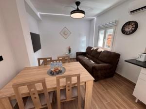 a living room with a table and a couch at Apartamentos Cañada Sierra 23 in Talavera de la Reina +25 photos