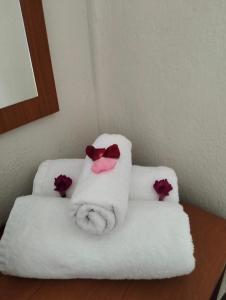 a white towel chair with a pink bow tie at Hotel Eleni in Paralia Dionysiou +87 photos