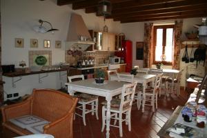 a kitchen with a table and chairs in a room at B&B La Casa Di Campagna in Bergamo