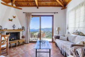 a living room with a couch and a fireplace at Kastanies Ananias Skopelos in Skopelos Town