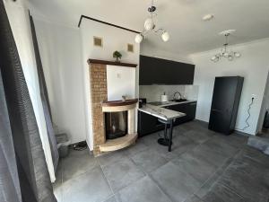a kitchen with a fireplace in the middle of a room at Mystegna beach 1 in Skala Mistegnon