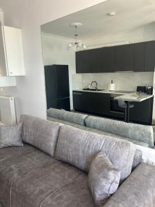 a couch in a living room with a kitchen at Mystegna beach 1 in Skala Mistegnon +9 photos