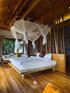 a bedroom with a large bed with a canopy at Mường Lò Retreat Nghia Lo in Yên Bái +84 photos