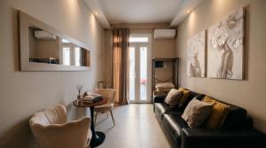 a living room with a couch and a table at charme suite delux in Terrasini