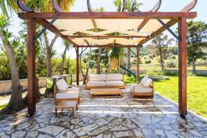 a gazebo with two couches and chairs on a patio at Vamavi Maison - Villa with Private Pool, Salamina in Salamina