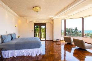 a bedroom with a bed and a view of the ocean at Vamavi Maison - Villa with Private Pool, Salamina in Salamina +43 photos