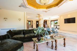 a living room with a couch and a table at Vamavi Maison - Villa with Private Pool, Salamina in Salamina
