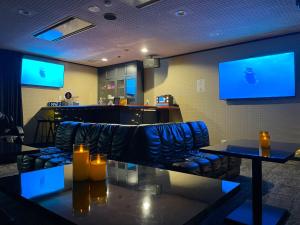 a bar with blue chairs and tables in a restaurant at 貸切宿さうなす in Nasushiobara +163 photos