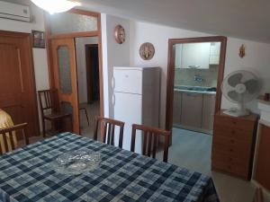 a kitchen and dining room with a table and a refrigerator at La casa di Rosy in Alba Adriatica