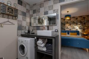 a bathroom with a sink and a washing machine at La Chambre Loft in Hennebont +17 photos