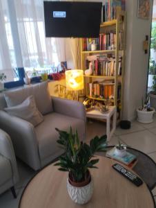 a living room with a couch and a table at Hotel Eleni in Paralia Dionysiou