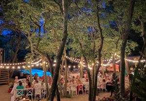 a group of people sitting in chairs under lights at MAS DEL CA Adult Only in Sorède +49 photos
