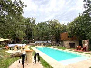 a swimming pool with chairs and a bar next to it at MAS DEL CA Adult Only in Sorède