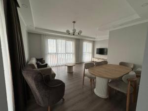 a living room with a table and chairs at Santana Suıts in Trabzon