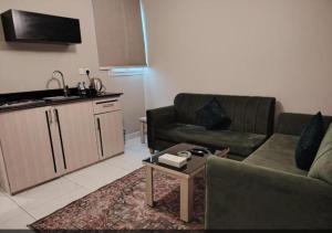 a living room with a couch and a table at شقق ازار المخدومه in Medina +48 photos