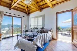 a living room with a couch and a table at Kastanies Ananias Skopelos in Skopelos Town