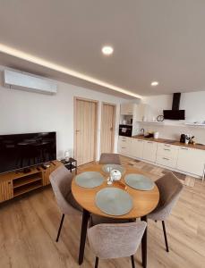 a dining room table and chairs in a kitchen at Theodora Apartman in Zánka