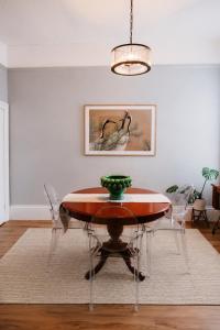 a dining room with a table and chairs at Charm on Forster in Invermay +21 photos