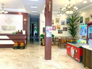 a restaurant lobby with a dining area and a table at Nam Xuan Premium Hotel in Da Lat