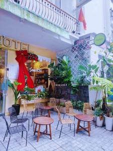 a group of tables and chairs in front of a store at Nam Xuan Premium Hotel in Da Lat