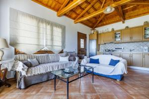 a living room with a couch and a table at Kastanies Ananias Skopelos in Skopelos Town