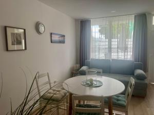 a living room with a table and a couch at Theodora Apartman in Zánka