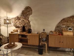 a room with wooden furniture and a stone wall at DEMIVIE GUESTHOUSE in Lerici