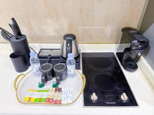 a drying tray with bottles of water on top of a sink at HOMETEL An Nahdah in Jeddah