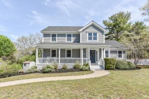 a white house with a porch and a driveway at Corn Hill Ranch in Falmouth +32 photos