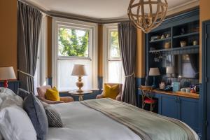 a bedroom with a large bed and a window at The Canford in Poole