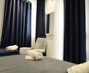 a bedroom with a bed with two towels on it at Hotel Riviera in Durrës +50 photos