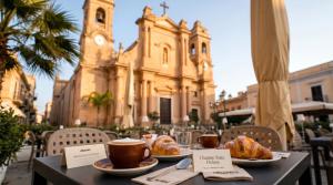 a table with two plates of pastries and cups of coffee at charme suite delux in Terrasini