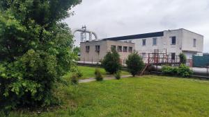 a factory with a grassy field in front of it at Pavelkova House in Olomouc
