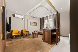 a living room with yellow chairs and a table at Taksim Premium Residence in Istanbul