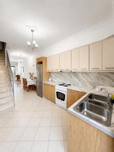 a kitchen with a sink and a stove at Ethereal Villas Lefkas in Nydri