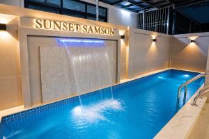 a swimming pool with a water feature in a building at Sunset Samson Hotel in Sầm Sơn