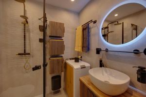 a bathroom with a sink and a mirror at Seefeld ALPIN Apartments in Seefeld in Tirol