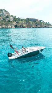 a group of people in a boat in the water at Hugo Experience - Taormina boat tour in Taormina