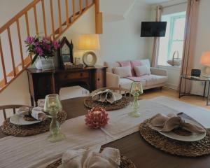 a living room with a table with hats on it at Foxglove Cottage in Killean