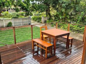a wooden table and two chairs on a deck at 46 Minerva Avenue in Pennington