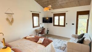 a living room with a bed and a couch at River Breeze Douro - Casa Touriga in Marmelal