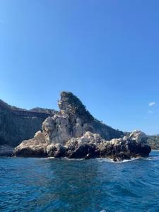 a small island in the water on the ocean at Hugo Experience - Taormina boat tour in Taormina