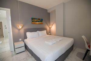 a bedroom with a large white bed with lights on it at 85 SOHO Premium Residences in Yangon